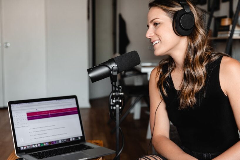 A woman recording a podcast in a studio